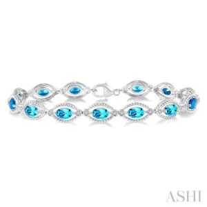 1/10 ctw Round Cut Diamond & 6x4 MM Oval Cut Blue Topaz Semi Precious Bracelet in Sterling Silver